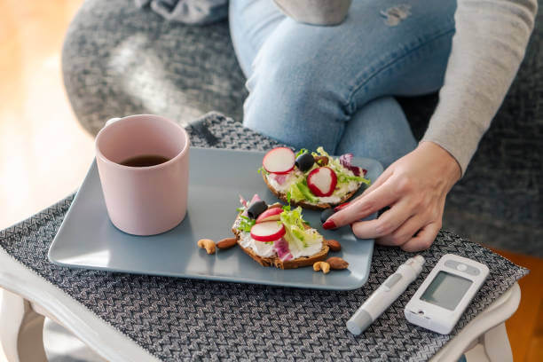 Young diabetic woman having breakfast at home.
